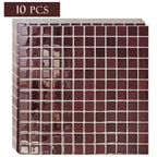 Stack of burgundy square mosaic peel-and-stick tile sheets